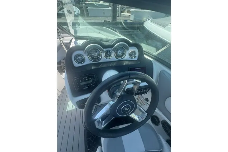 Slide: The Image of Steering console of a 2021 NauticStar 243 DC boat with gauges and controls. - 9