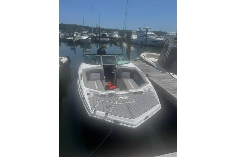 Slide: The Image of 2021 NauticStar 243 DC boat docked at marina, sunny day, calm waters. - 3