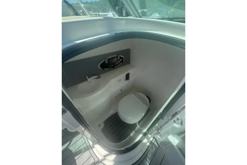 Slide: The Image of 2021 NauticStar 243 DC boat interior with compact marine toilet and sink. - 21