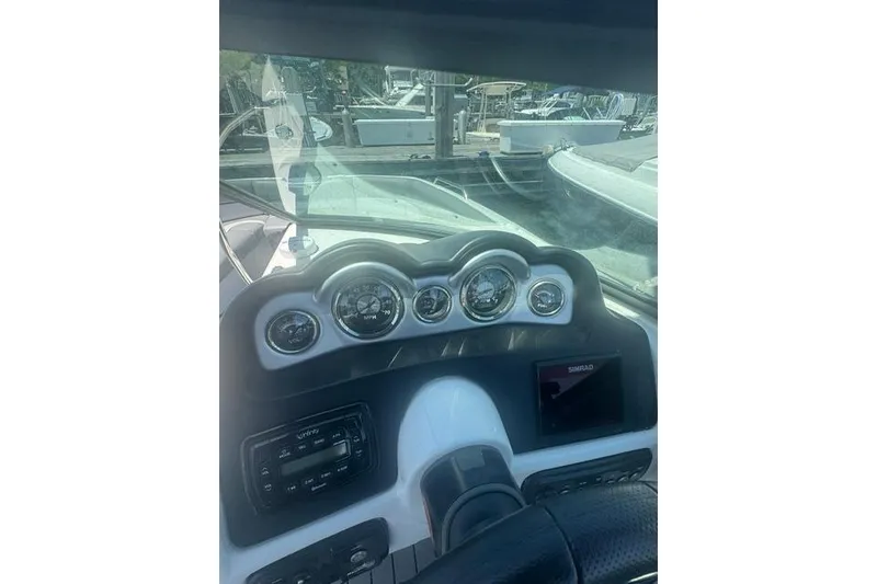 Slide: The Image of Dashboard of a 2021 NauticStar 243 DC boat with gauges and controls. - 11