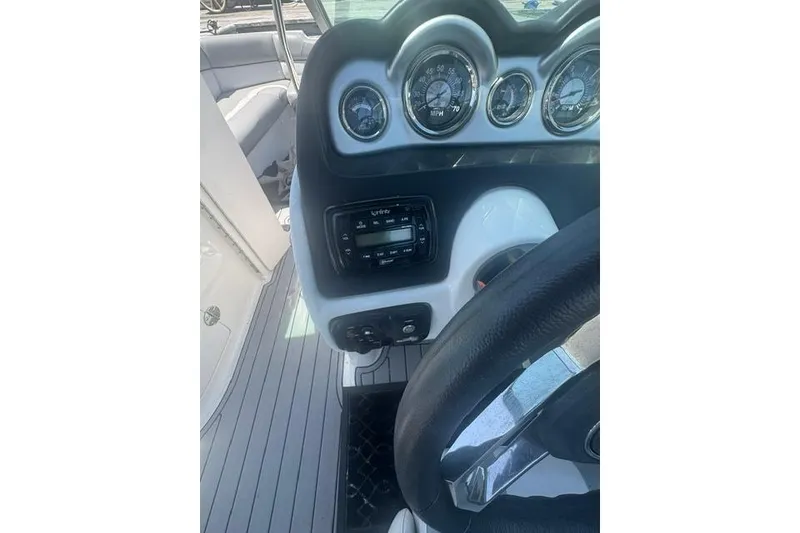 Slide: The Image of 2021 NauticStar 243 DC dashboard with gauges and controls, featuring a sleek design. - 10