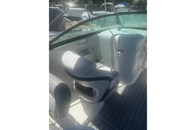 Slide: The Image of 2021 NauticStar 243 DC boat interior with seating and dashboard view. - 20
