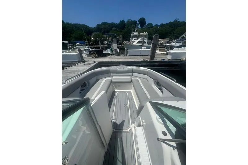 Slide: The Image of 2021 NauticStar 243 DC boat interior at a marina dock. - 4