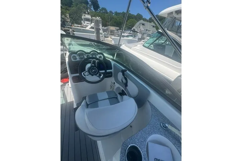 Slide: The Image of Interior view of 2021 NauticStar 243 DC boat cockpit with steering wheel and seating. - 8