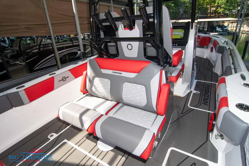Slide: The Image of Interior of a 2023 Fountain 32 NX with red and gray seating. - 22
