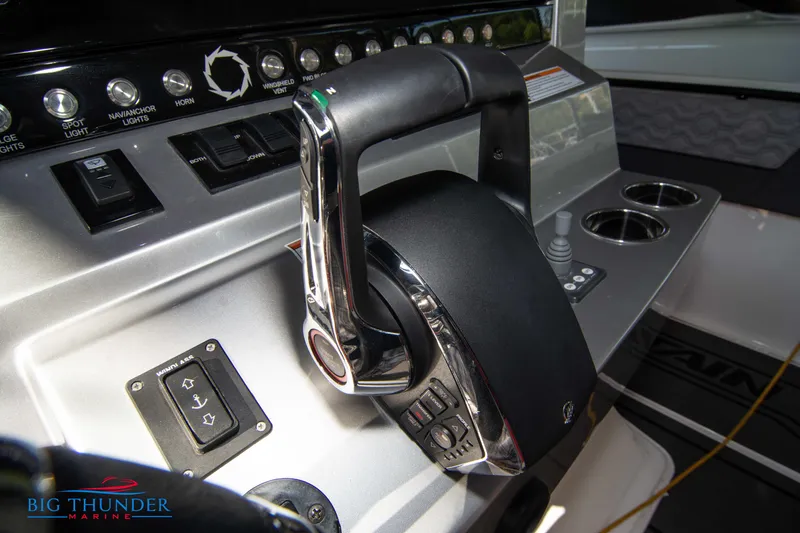 Slide: The Image of Close-up of the helm of a 2023 Fountain 32 NX with modern controls. - 44