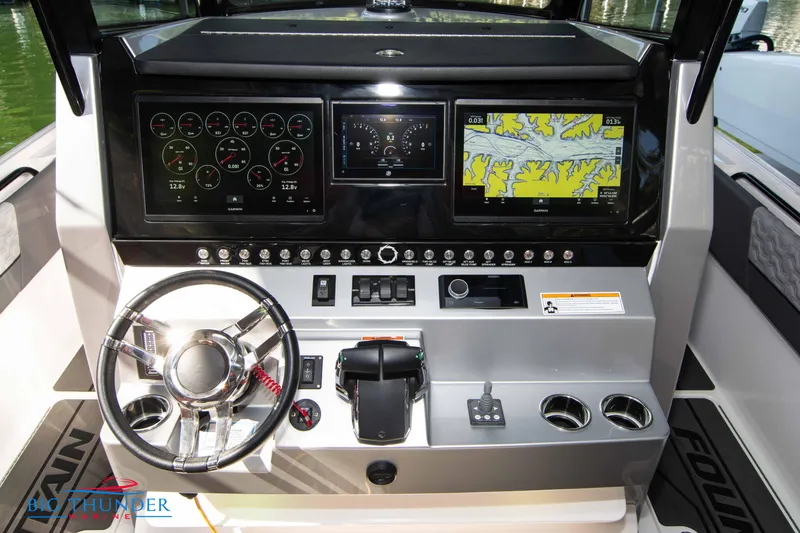 Slide: The Image of The 2023 Fountain 32 NX cockpit features a modern dashboard with multiple screens and instruments. - 32