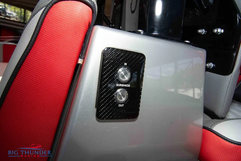 Slide: The Image of Close-up of a switch on a boat, surrounded by red and gray upholstery. - 28