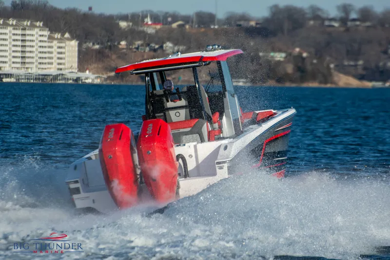 Slide: The Image of A 2023 Fountain 32 NX boat speeding on water, featuring two red outboard engines. - 6
