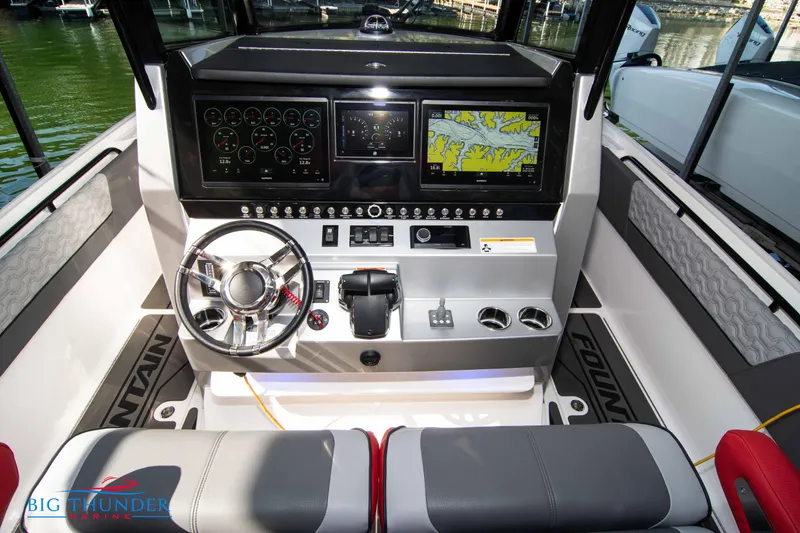Slide: The Image of The 2023 Fountain 32 NX cockpit features a modern dashboard with multiple screens. - 31