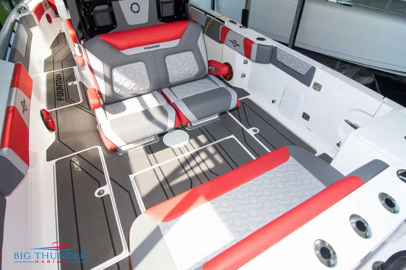Slide: The Image of The image shows the cockpit of a 2023 Fountain 32 NX boat with gray and red seating. - 18