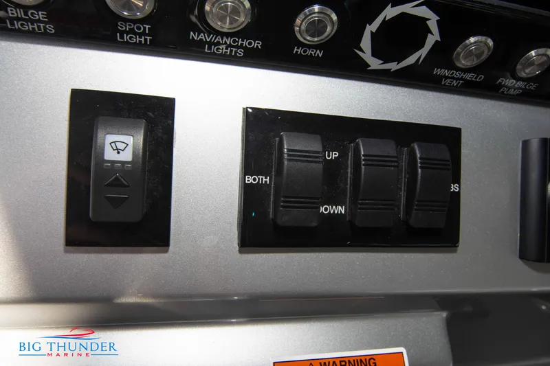 Slide: The Image of Control panel of the 2023 Fountain 32 NX with various switches and buttons. - 42