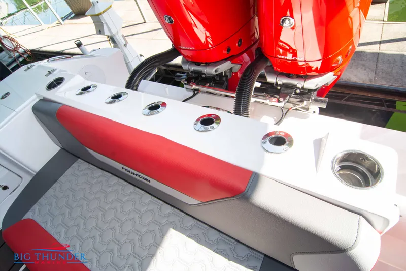 Slide: The Image of The image shows the stern of a 2023 Fountain 32 NX boat with red engines. - 20