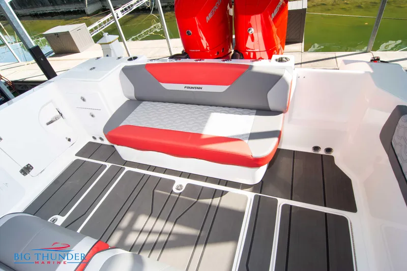 Slide: The Image of The image shows the cockpit of a 2023 Fountain 32 NX with gray and red seating. - 19