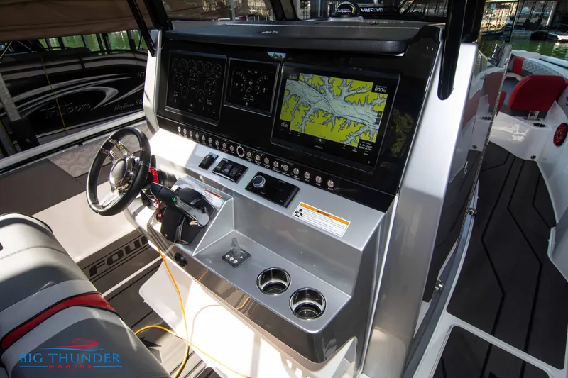 Slide: The Image of The image shows the cockpit of a 2023 Fountain 32 NX with modern navigation systems. - 33