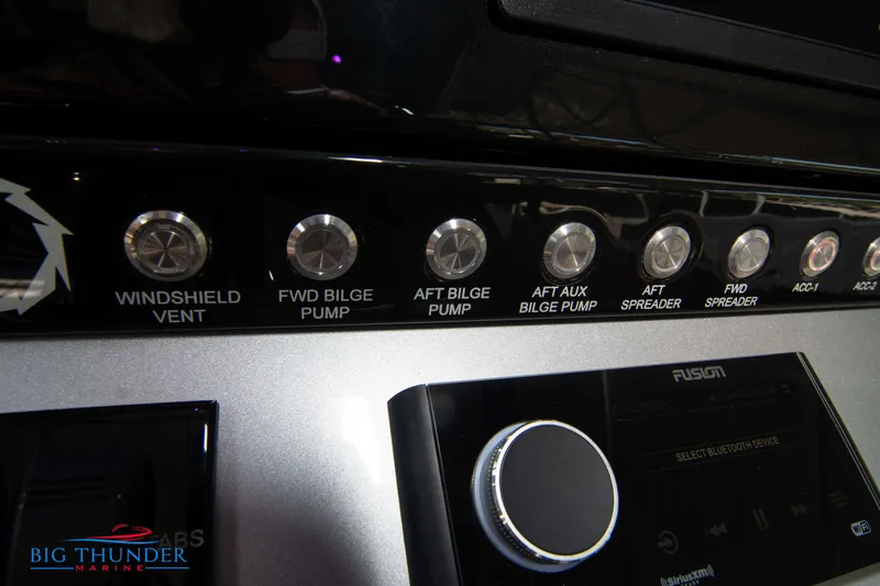 Slide: The Image of Close-up of the control console with various switches and a Fusion audio system. - 39