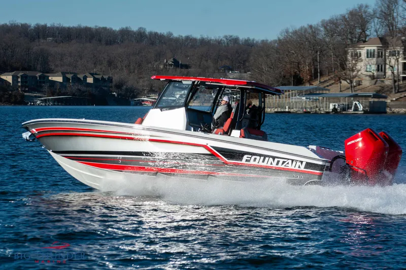 Slide: The Image of Fountain 32 NX 2023 on a lake with red accents and twin outboard engines. - 13