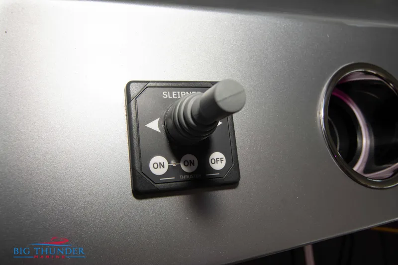 Slide: The Image of Close-up of a joystick on a boat dashboard, surrounded by a vent outlet. - 43