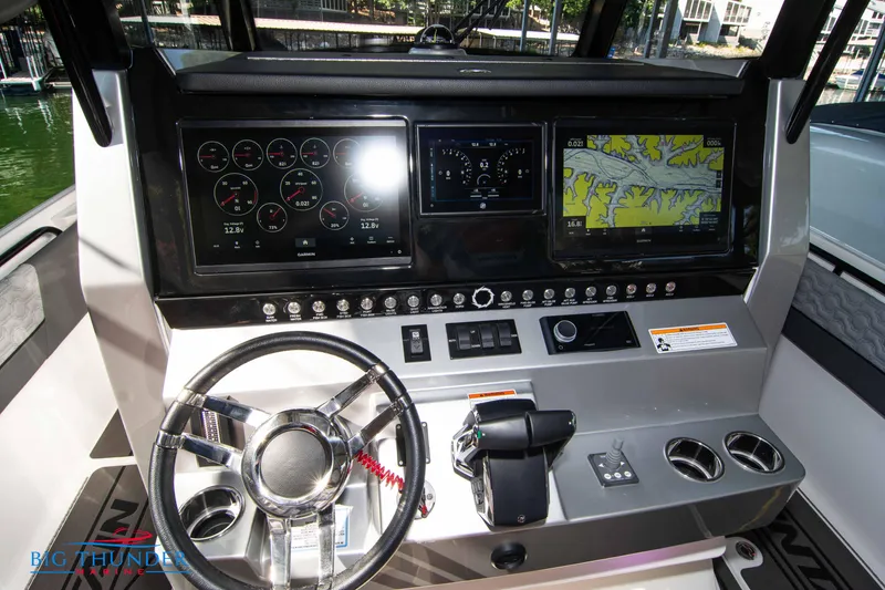Slide: The Image of The 2023 Fountain 32 NX cockpit features a modern dashboard with multiple screens and a stylish steering wheel. - 35
