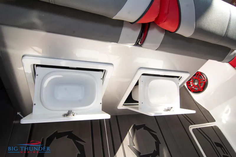Slide: The Image of Two open storage compartments on a boat with gray and red upholstery. - 48
