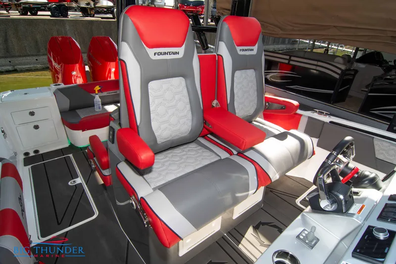 Slide: The Image of The 2023 Fountain 32 NX features luxurious red and gray seating in the cockpit area. - 46