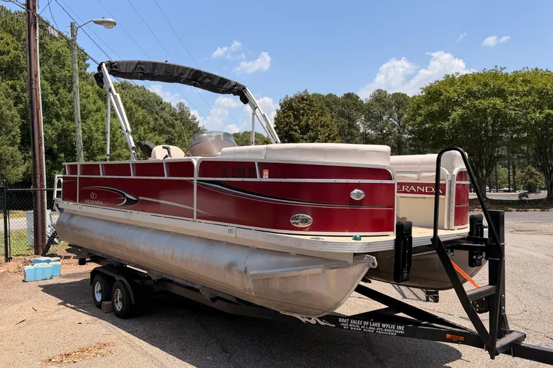 The Image of 2013 Veranda 24 pontoon boat on trailer, red and white design, parked outdoors. - 1