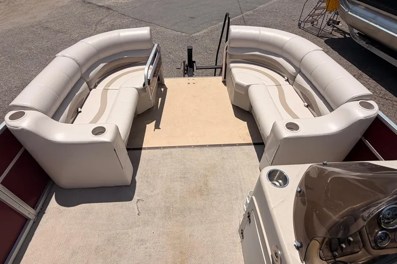 Slide: The Image of 2013 Veranda 24 pontoon boat interior with beige seating and cup holders. - 11