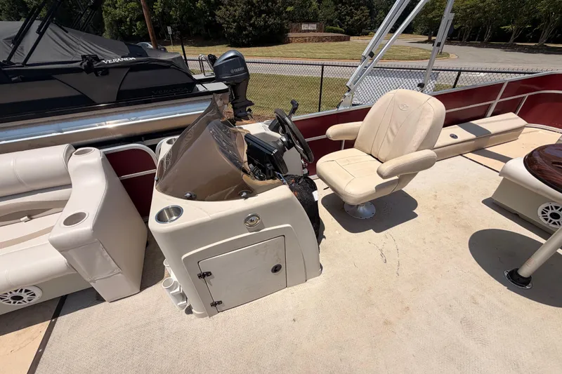 Slide: The Image of 2013 Veranda 24 boat interior with steering console and seating area. - 6