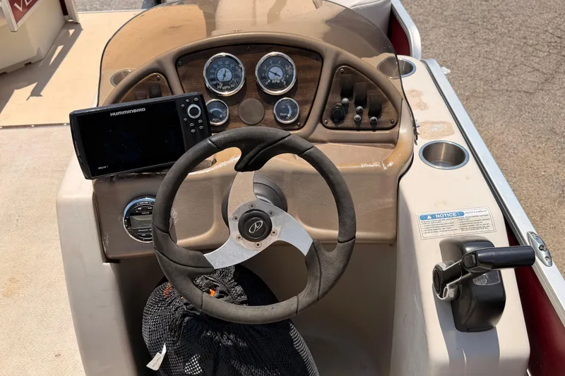 Slide: The Image of Steering console of a 2013 Veranda 24 boat with gauges and Humminbird electronics. - 10