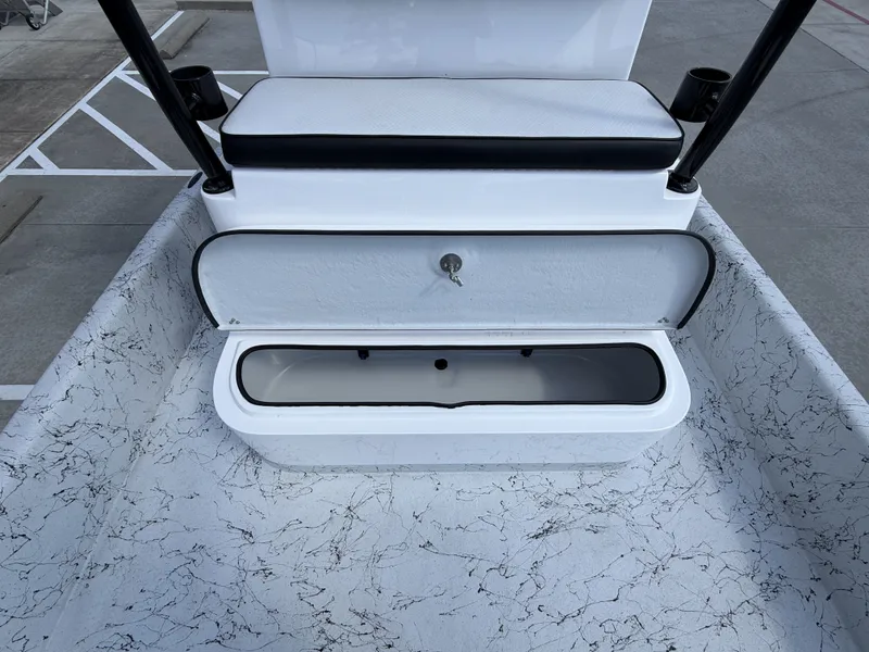 Slide: The Image of The image shows the rear area of a Dargel 250 Kat HDX boat with a white bench seat and storage compartment underneath. - 28