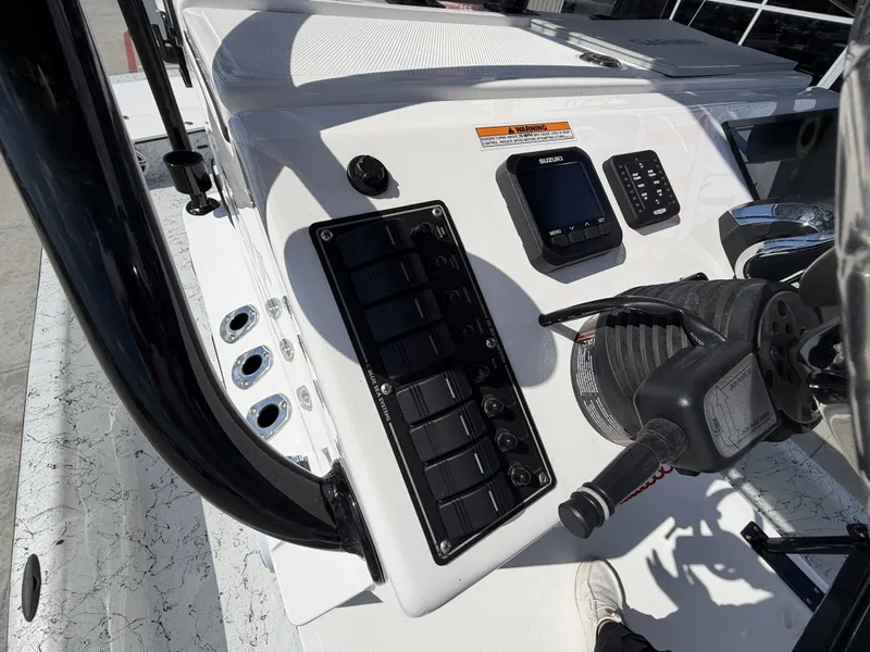 Slide: The Image of The image shows the helm of a Dargel 250 Kat HDX boat with modern instruments. - 18