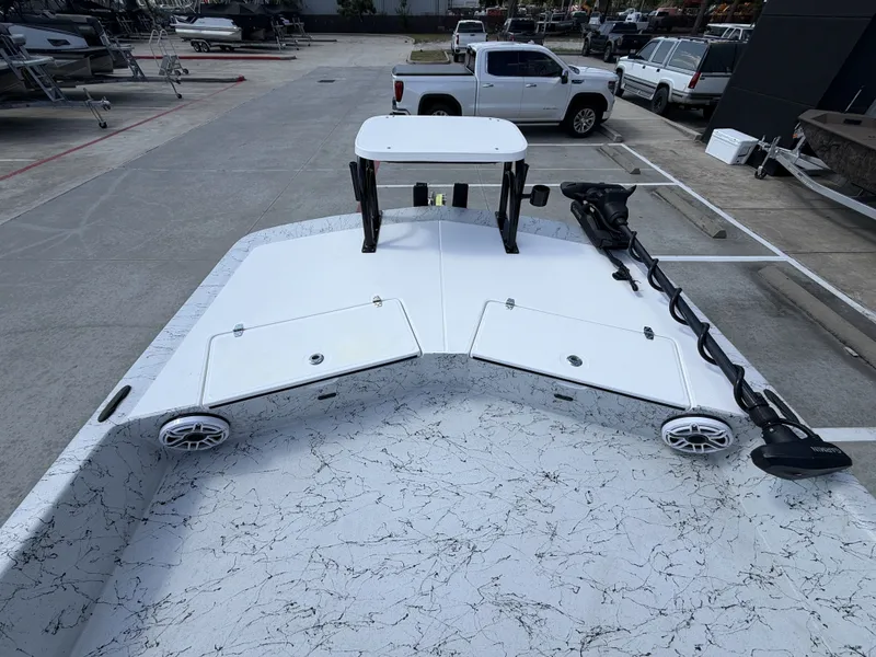 Slide: The Image of The image shows the deck of a 2026 Dargel 250 Kat HDX boat with storage hatches and a trolling motor. - 25