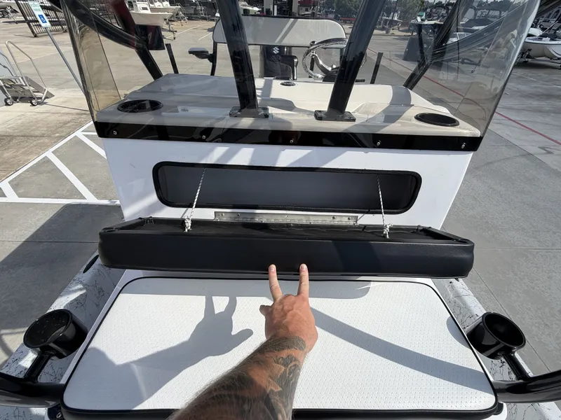 Slide: The Image of A boat with a white seating area and black cushion. A tattooed hand shows a peace sign. - 31