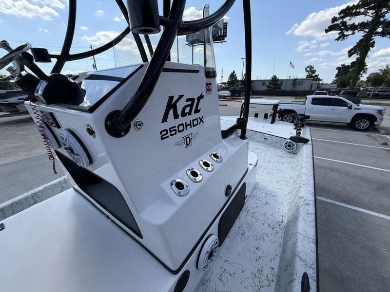 Slide: The Image of Dargel 250 Kat HDX 2026: A modern boat with sleek design, parked at a marina. - 21