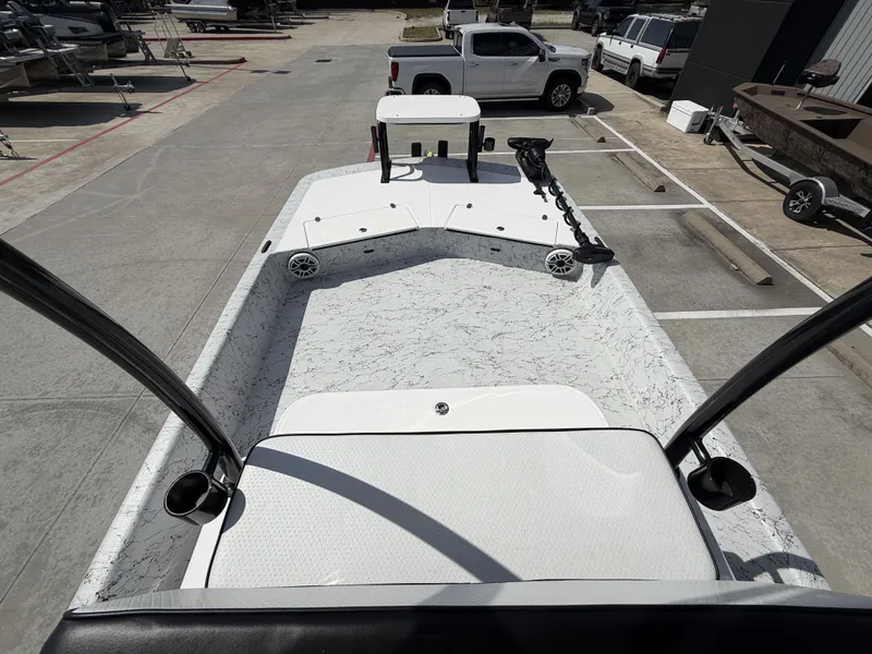 Slide: The Image of The image shows a 2026 Dargel 250 Kat HDX boat. It is parked in a lot, surrounded by other vehicles. The deck is clean and modern. - 24