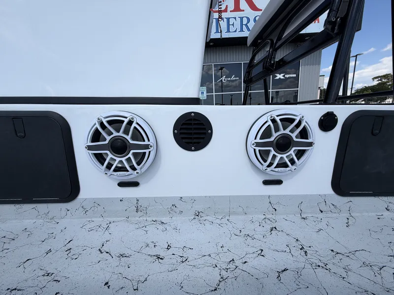Slide: The Image of Speakers on a boat with a marbled floor and black accessories. - 23