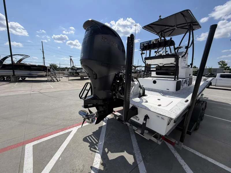Slide: The Image of A 2026 Dargel 250 Kat HDX boat is parked on a lot. It features a large outboard motor. - 9