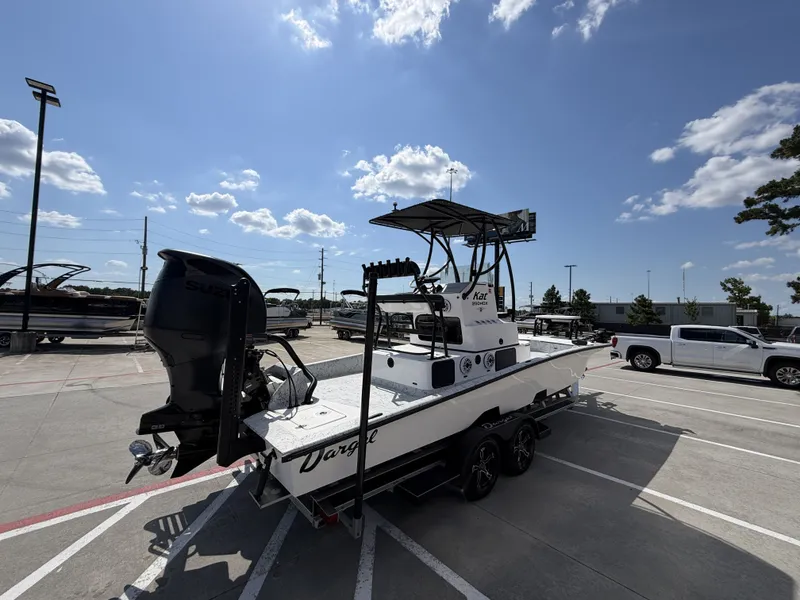 Slide: The Image of A 2026 Dargel 250 Kat HDX boat is on a trailer in a parking lot. - 7