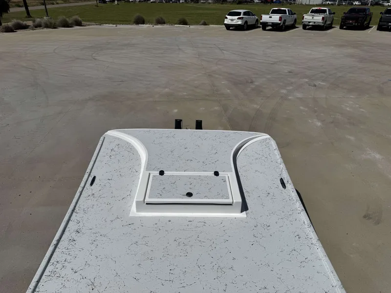 Slide: The Image of The image shows the deck of a 2024 Shallow Stalker 20 PRO boat in a parking lot. - 19