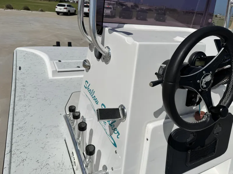 Slide: The Image of The image shows the helm of a 2024 Shallow Stalker 20 PRO boat. - 13