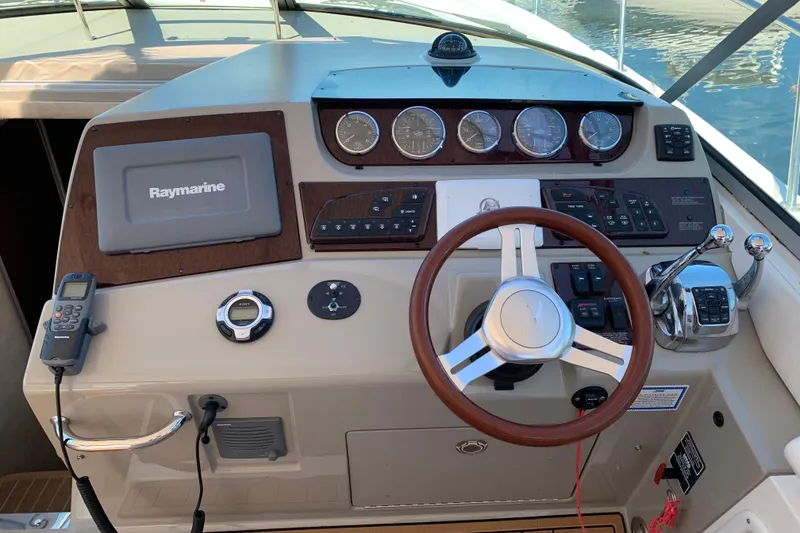 Slide: The Image of Helm of 2011 Sea Ray Sundancer 370 with Raymarine navigation system and classic steering wheel. - 31