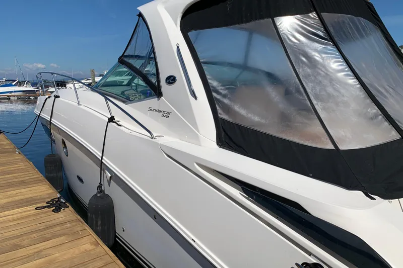 Slide: The Image of 2011 Sea Ray Sundancer 370 docked at marina, side view with clear canopy. - 19
