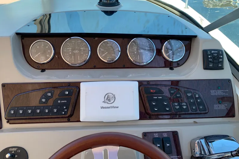 Slide: The Image of Dashboard of a 2011 Sea Ray Sundancer 370 boat with gauges and controls. - 32