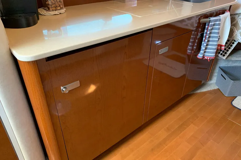 Slide: The Image of Interior view of 2011 Sea Ray Sundancer 370, featuring polished wood cabinetry and countertop. - 39