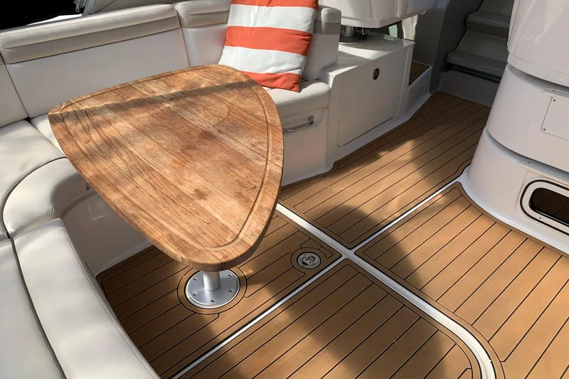 Slide: The Image of 2011 Sea Ray Sundancer 370 interior with wooden table and cushioned seating. - 21