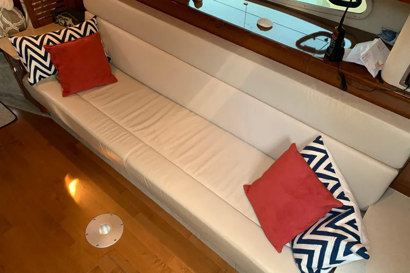 Slide: The Image of Luxurious interior of 2011 Sea Ray Sundancer 370 with white leather seating and decorative pillows. - 36