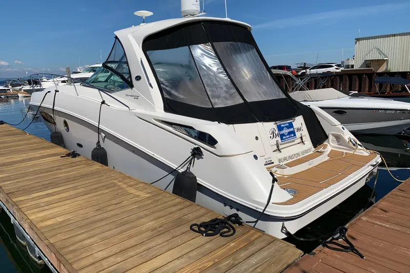 Slide: The Image of 2011 Sea Ray Sundancer 370 docked at marina, featuring sleek design and spacious deck. - 17