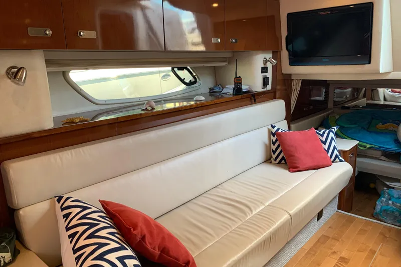 Slide: The Image of Interior of 2011 Sea Ray Sundancer 370 yacht with sofa, pillows, and TV. - 41