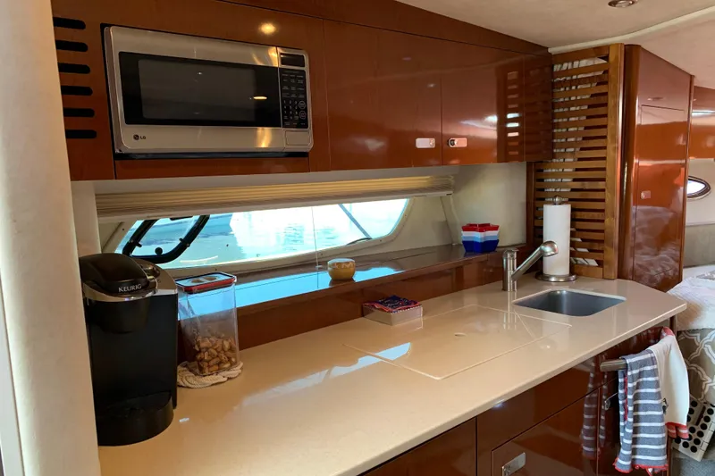 Slide: The Image of Luxurious kitchen area in a 2011 Sea Ray Sundancer 370 yacht with modern amenities. - 38