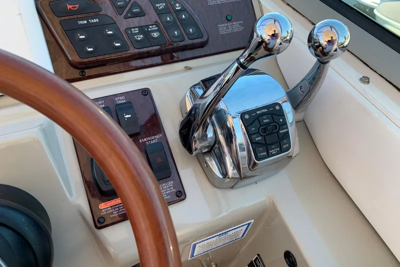 Slide: The Image of Control panel of a 2011 Sea Ray Sundancer 370 boat with throttle levers. - 33